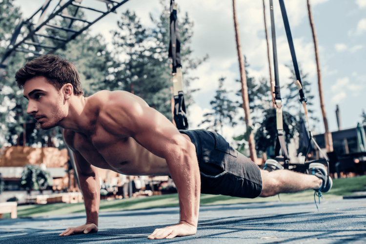 Man doing a press up outside