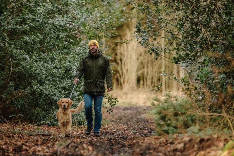 Ross Tomkins, the founder of Alphagenix, outside in winter clothes, walking his dog