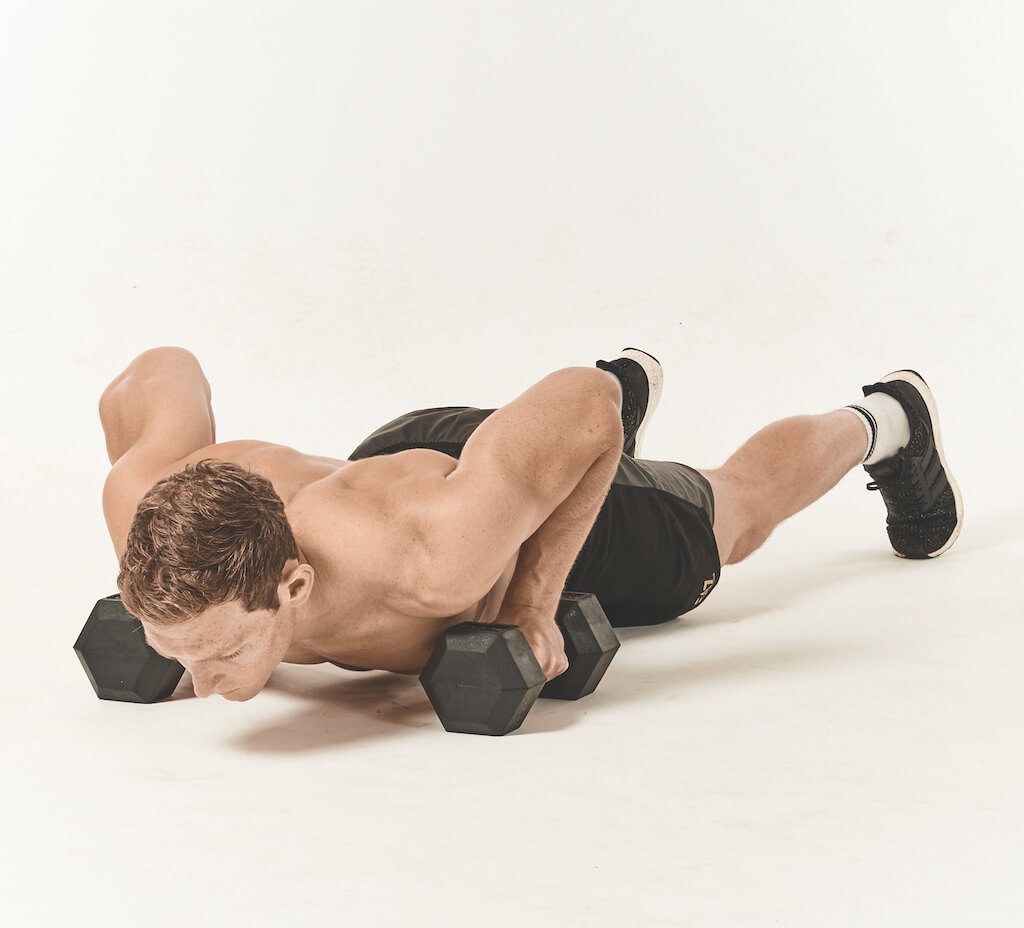 Man performing a push-up with renegade row