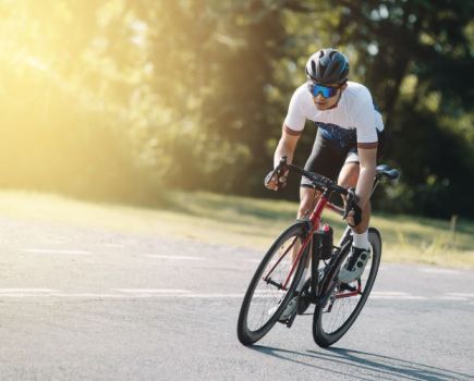 A road cyclist riding out of the saddle