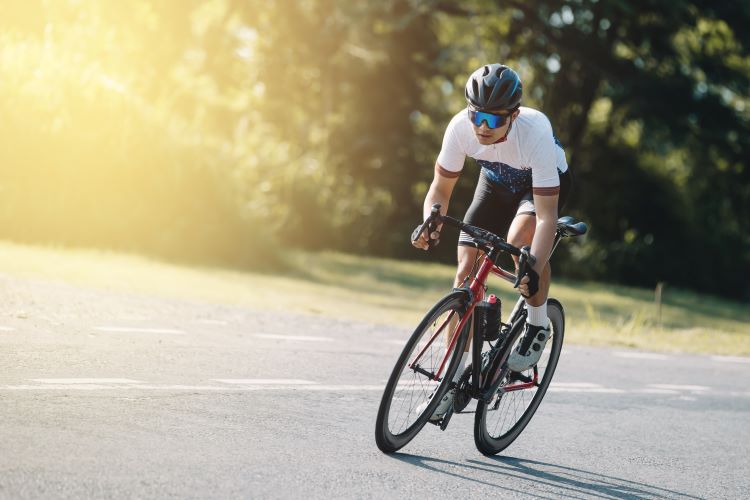 A road cyclist riding out of the saddle