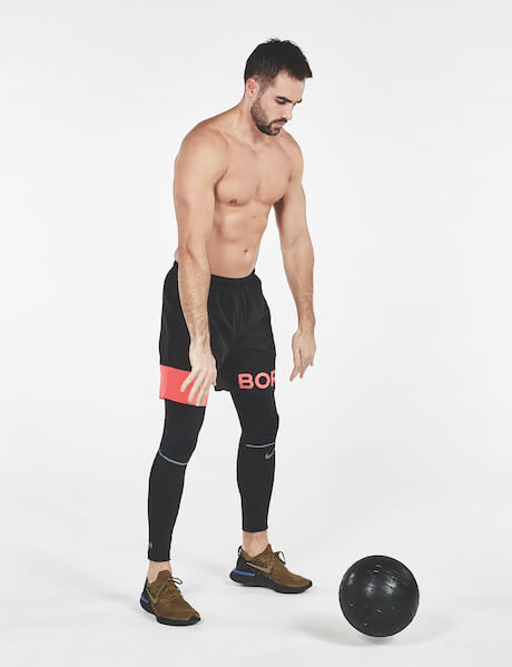 Man performing medicine ball slam