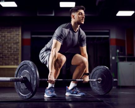 Man performing a deadlift with a barbell