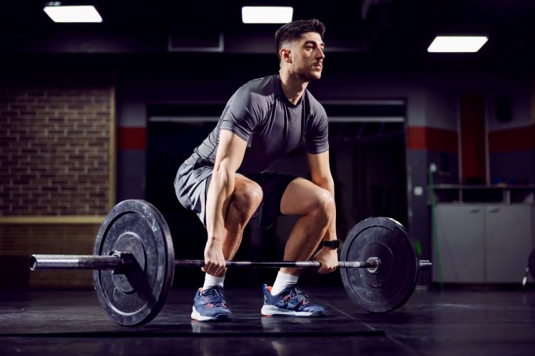 Man performing a deadlift with a barbell