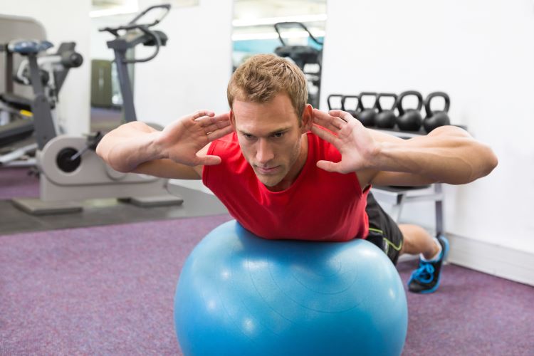 Man exercising on a gym ball