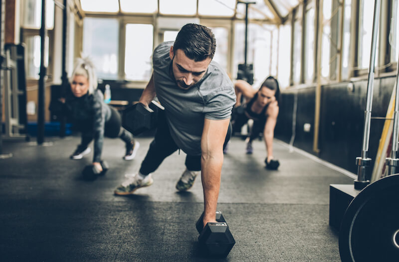 man performing renegade row