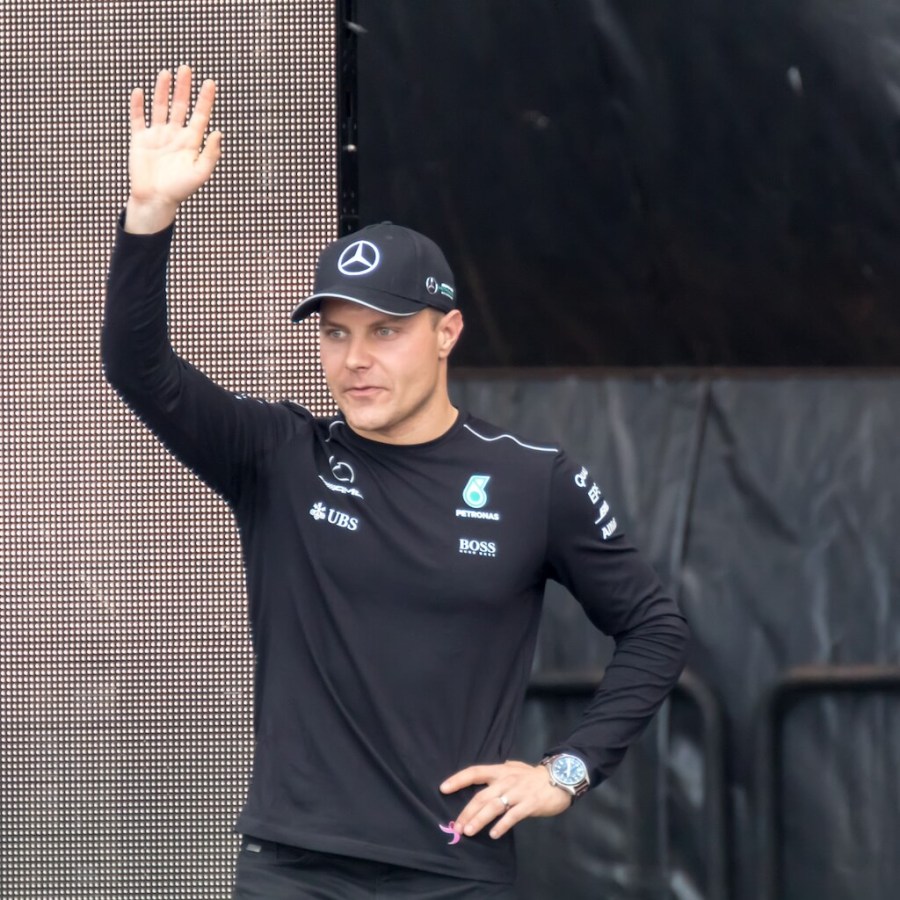 F1 driver Valterri Bottas waving to fans