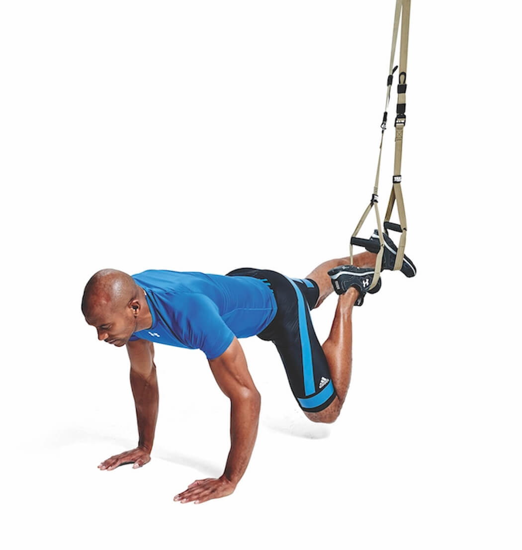 man performing TRX mountain climber