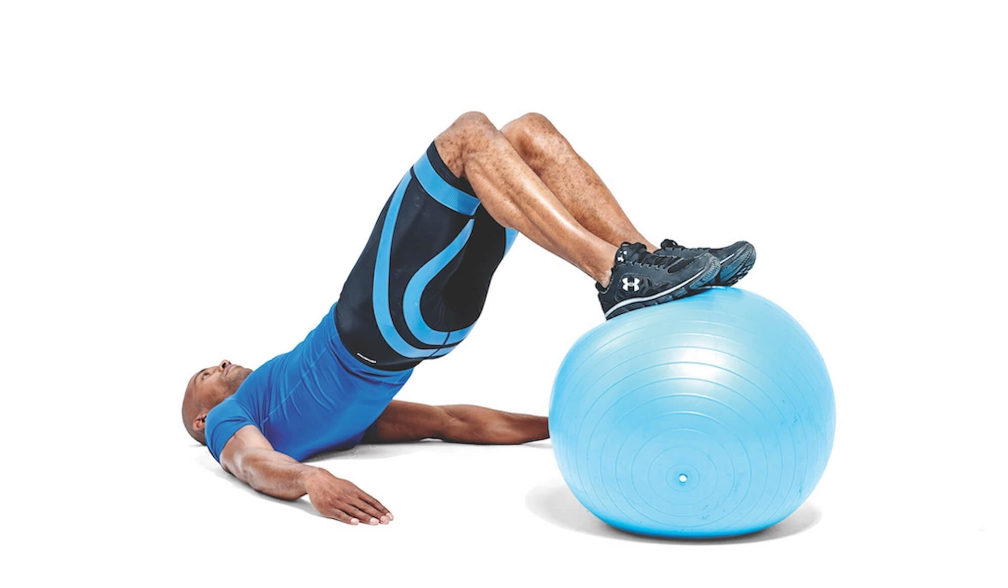 man performing gym ball hamstring curl