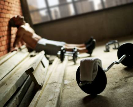 exhausted man in the gym, with weights on the floor