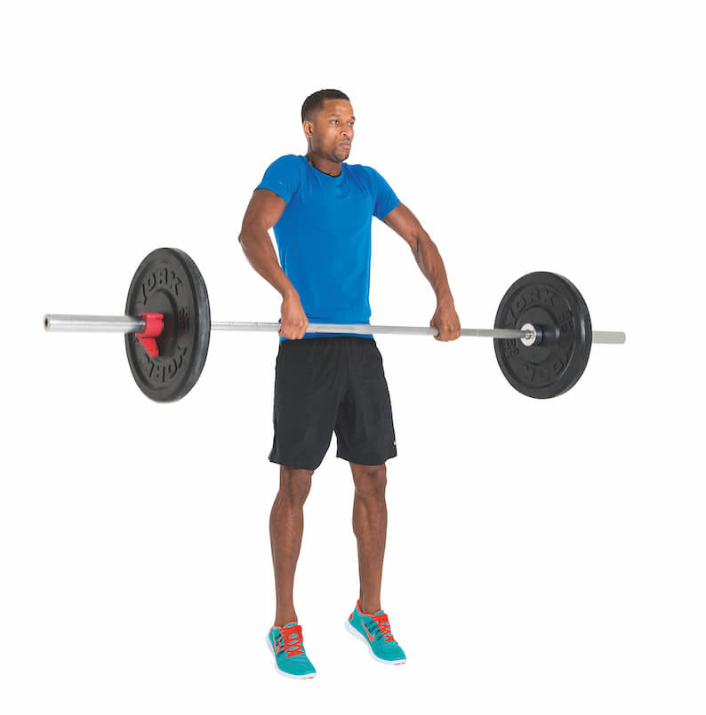 man performing jump shrug as part of Men's Fitness cover model workout plan