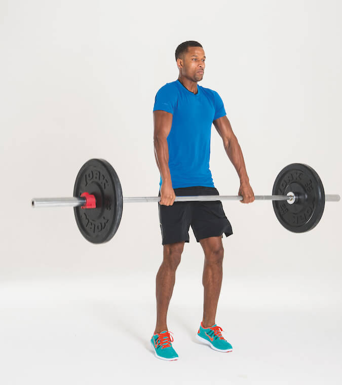 man performing barbell hang squat clean