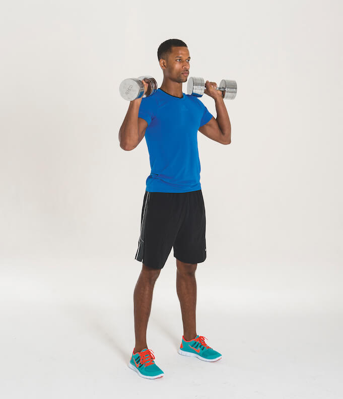 man performing standing dumbbell overhead press