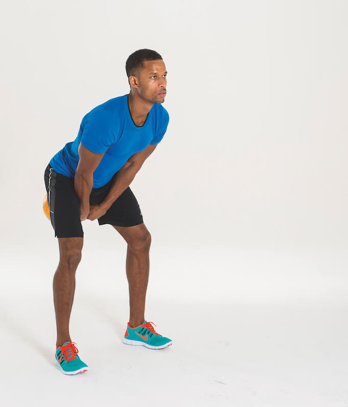 man performing kettlebell swing