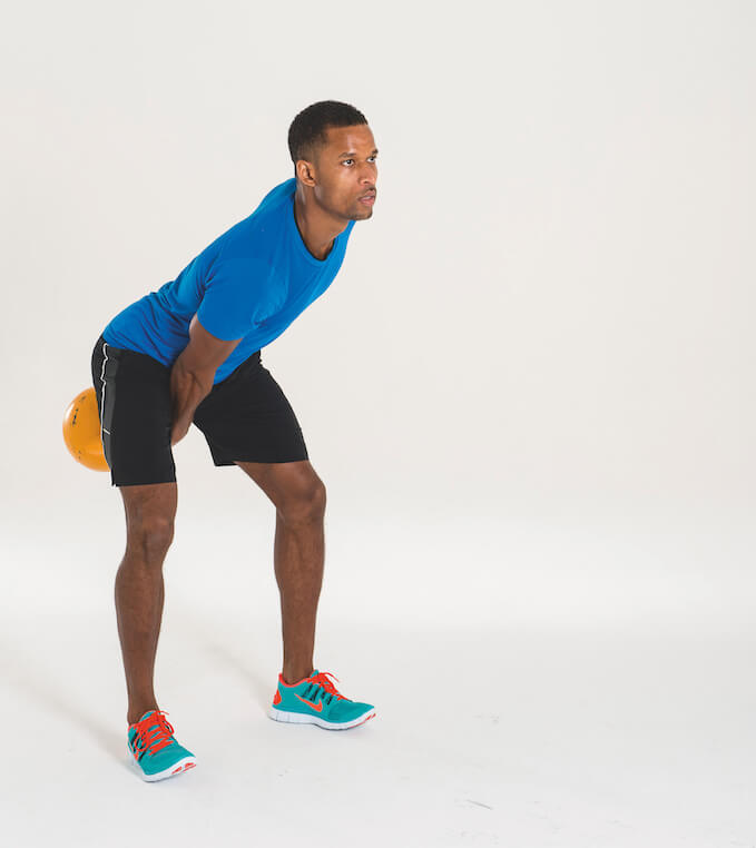 man performing kettlebell snatch