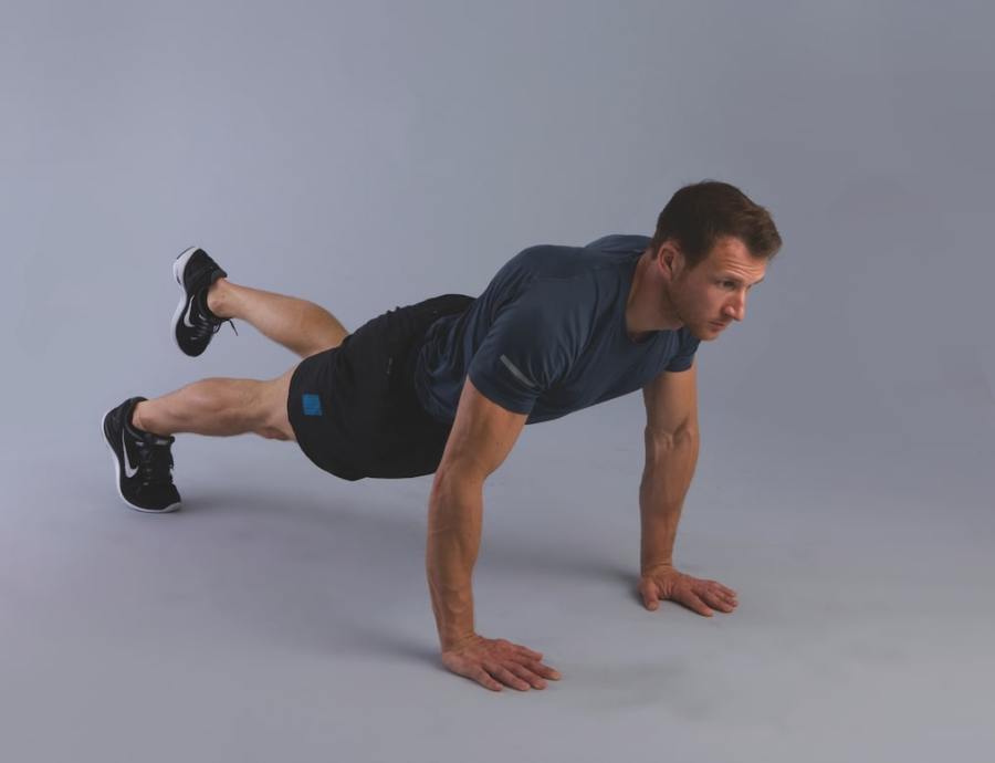 bodyweight hiit workout: man performing single-leg burpee