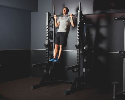 man performing burpee for a bodyweight EMOM workout