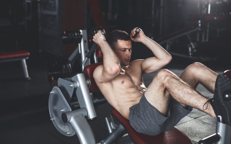 Man in a gym exercising on a hack squat machine