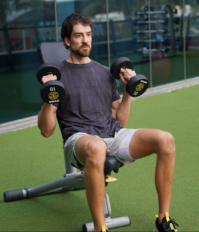 Man seated performing end of dumbbell hammer curl