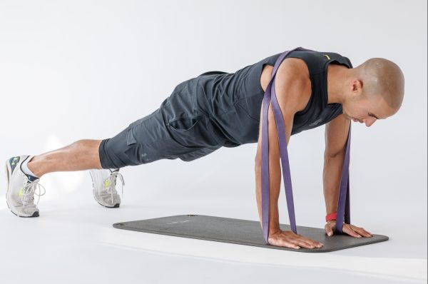 Man performing banded press-up