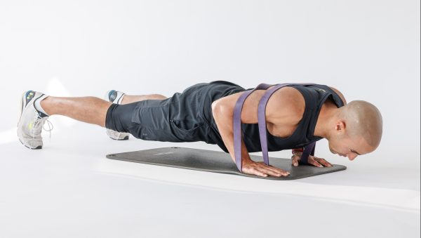 Man performing banded press-up