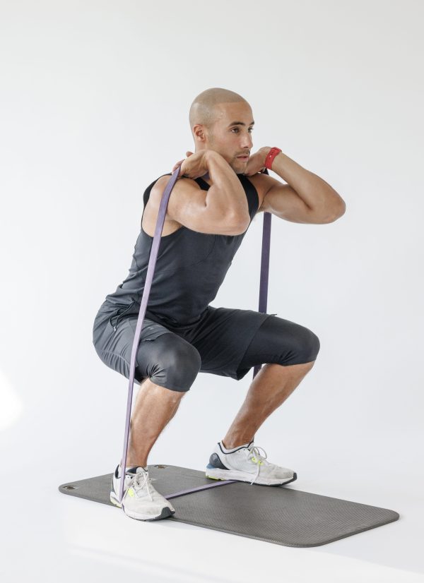 Man performing banded front squat