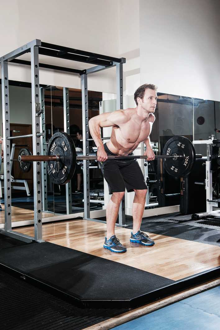 man demonstrates bent over barbell row