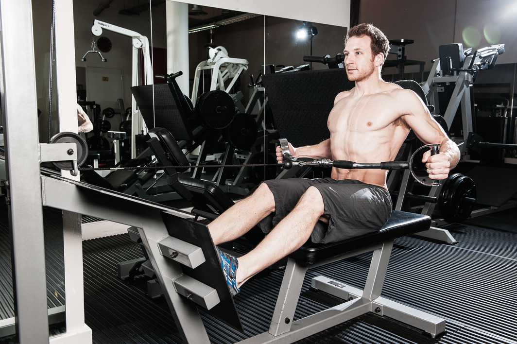 man demonstrates wide grip cable row how to build back muscles