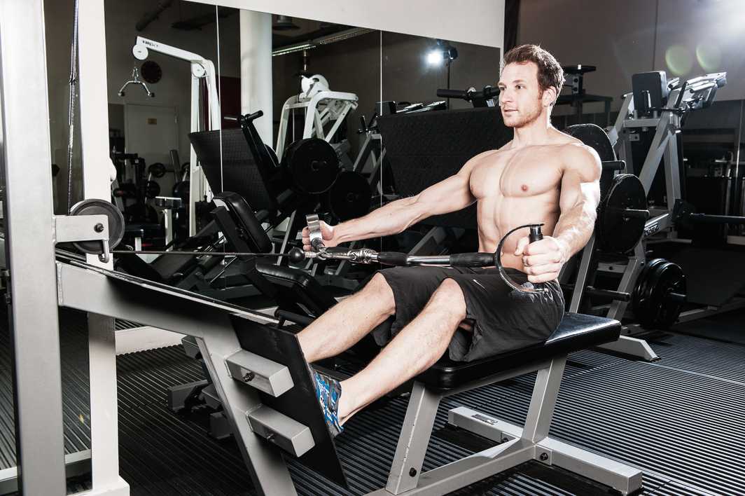 man demonstrates wide grip cable row