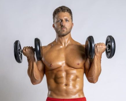 man demonstrates dumbbell zottman curl; he lifts two dumbbells until level with his shoulders