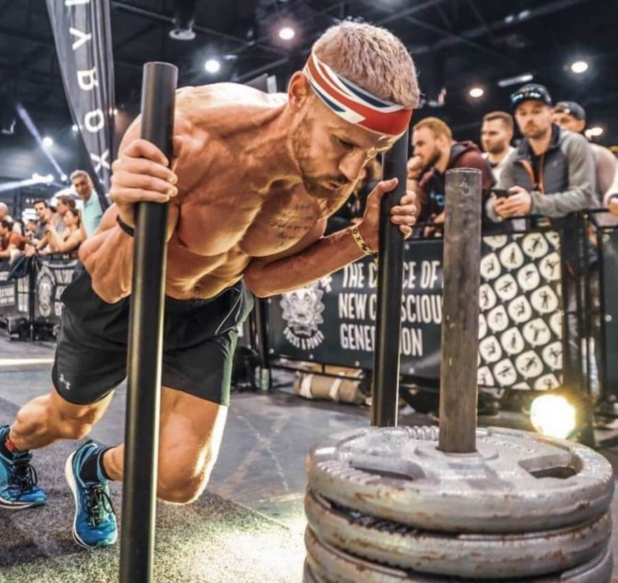 Michael Sandbach, the UK's fastest HYROX athlete, pushing a sled during a HYROX event