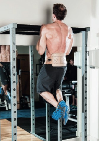 Man performing the end of the weighted chin-up - how to build bigger arm muscles