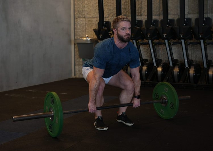 Man performs dumbbell deadlift - best deadlift variations