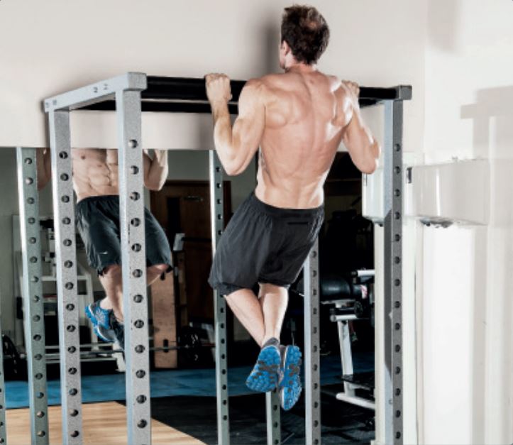 man demonstrates negative pull up in the gym