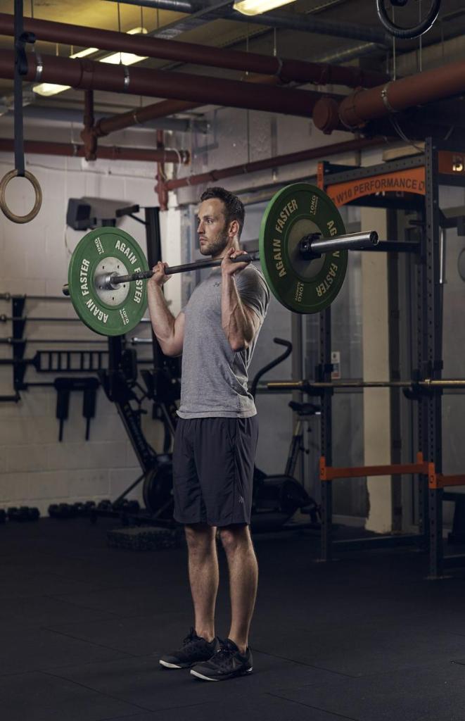 man demonstrating overhead press