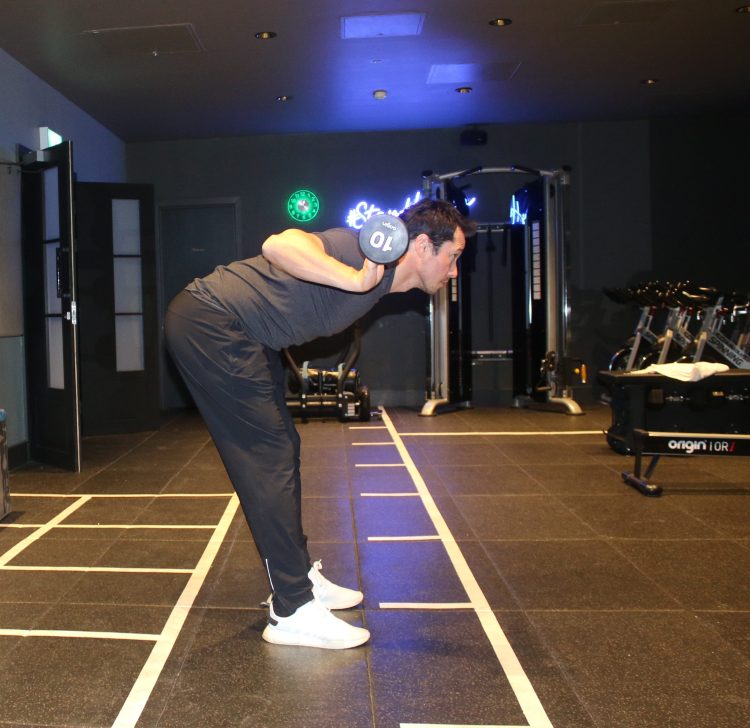 Man performing barbell good morning, bottom position - best lower back exercises