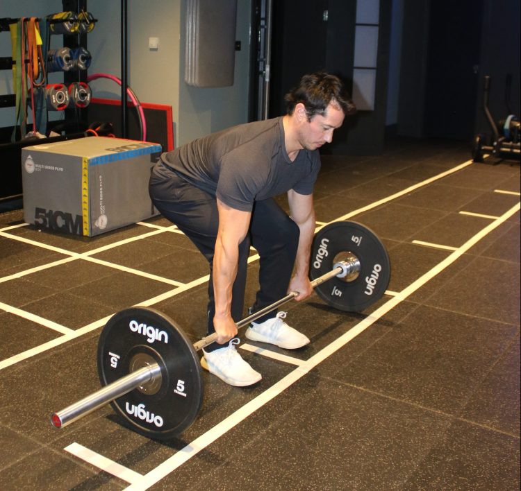 Man performing a conventional deadlift - best lower back exercises