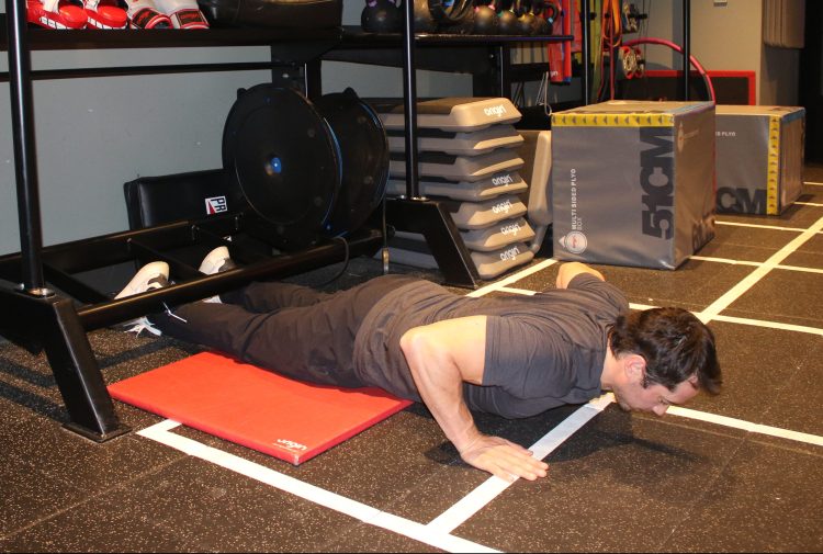 Man performing a Nordic hamstring curl - best lower back exercises