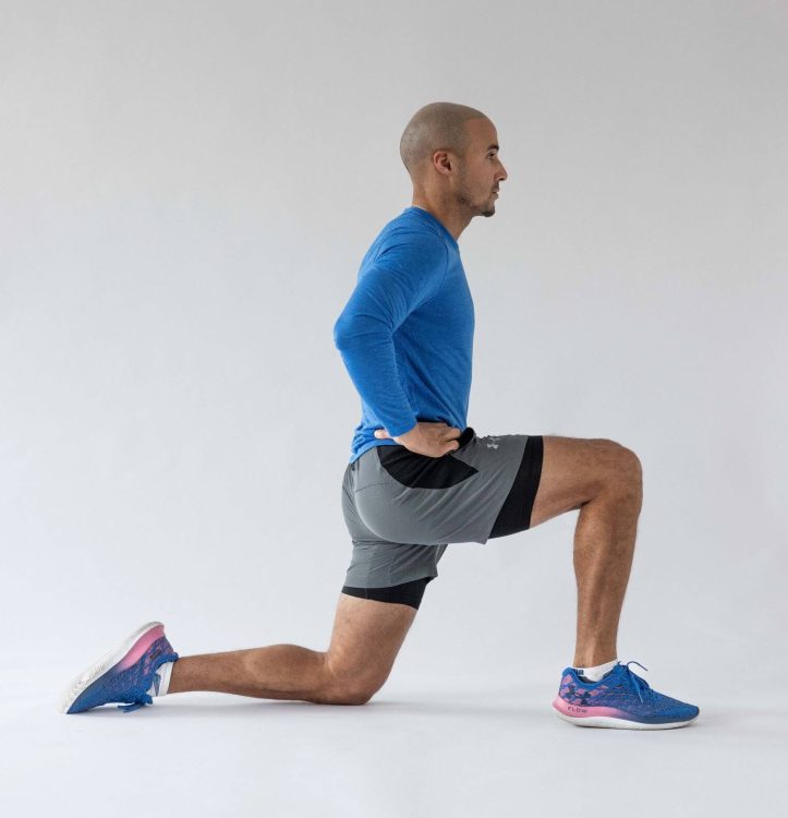 Man performing a lunge hip flexor stretch - best hip stretches