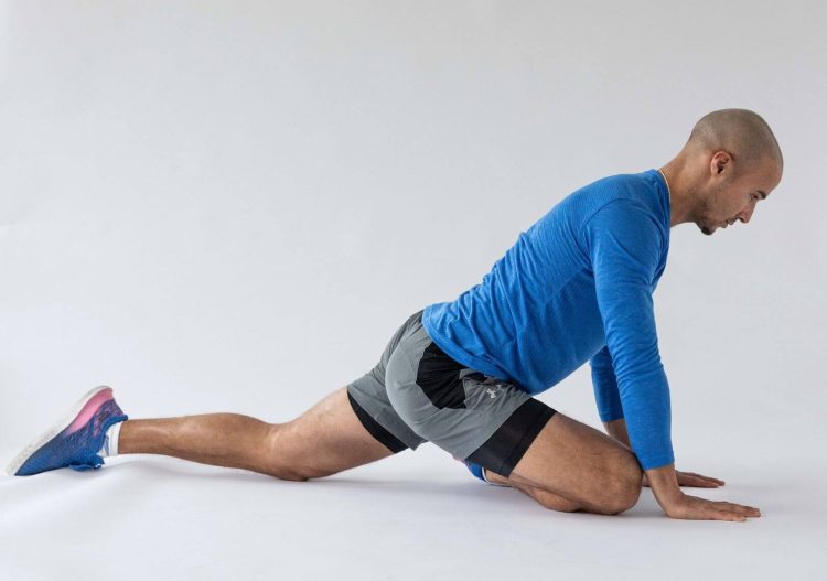 Man performing end of a pigeon stretch - best hip stretches