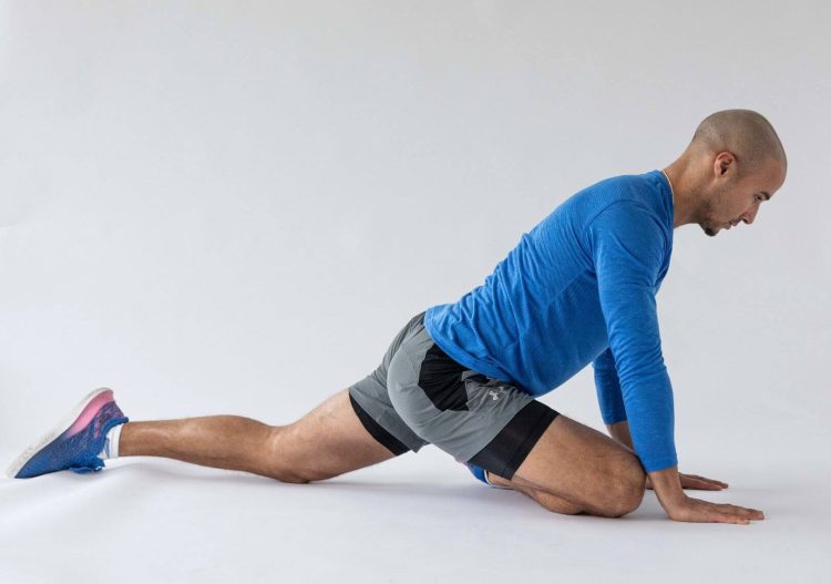 Man performing end of a pigeon stretch -