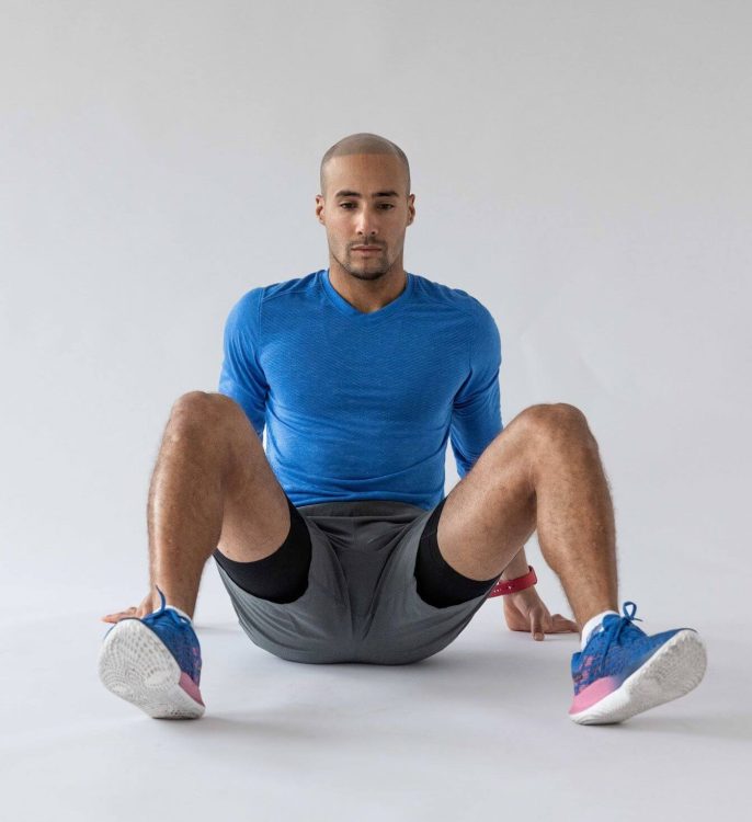 A man performing a 90/90 hip stretch - best hip stretches