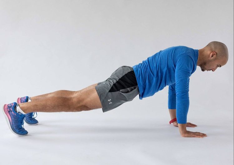 Man in a press-up position - best hip stretches