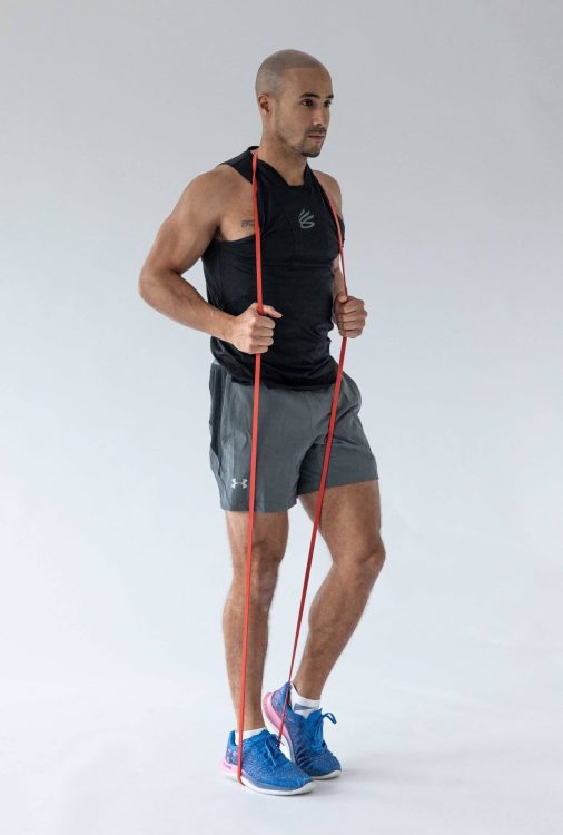 Man performing a banded reverse lunge - resistance band leg exercises