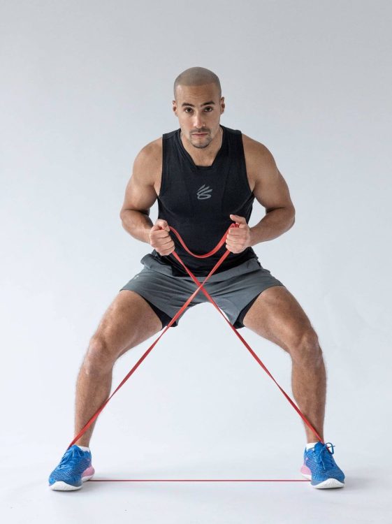 Man performing banded side steps - resistance band leg exercises