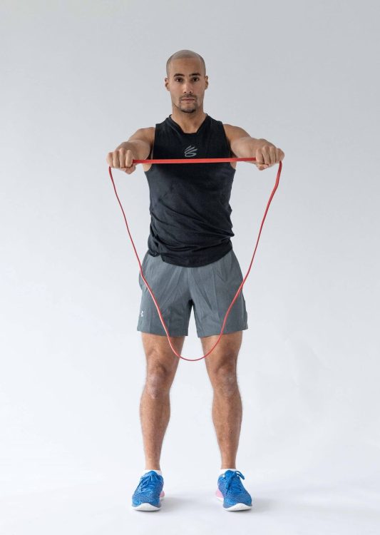 Man performing a band pull-apart - resistance band arm exercises