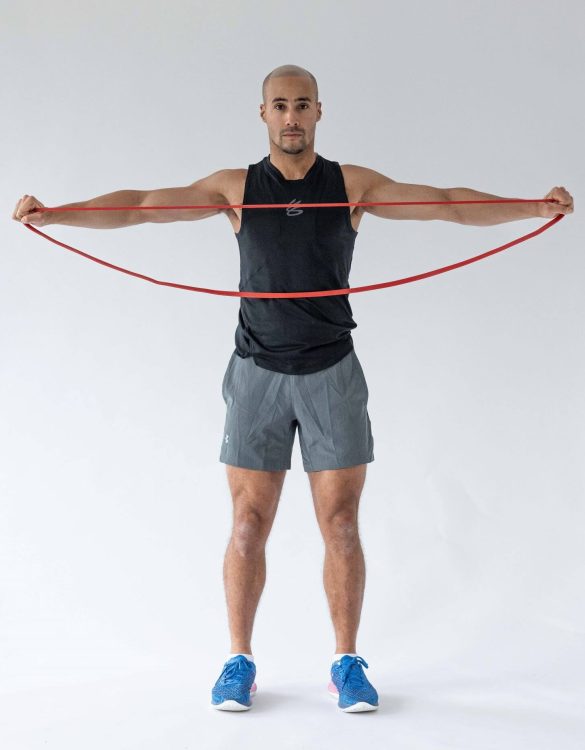 Man performing end of a band pull-apart - resistance band arm exercises