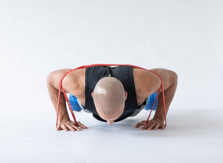 Man performing a banded press-up - resistance band arm exercises
