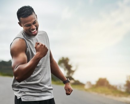 athletic man fist pumping the air in celebration