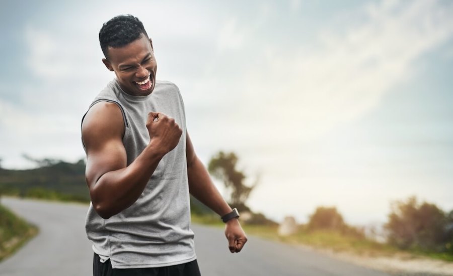 athletic man fist pumping the air in celebration